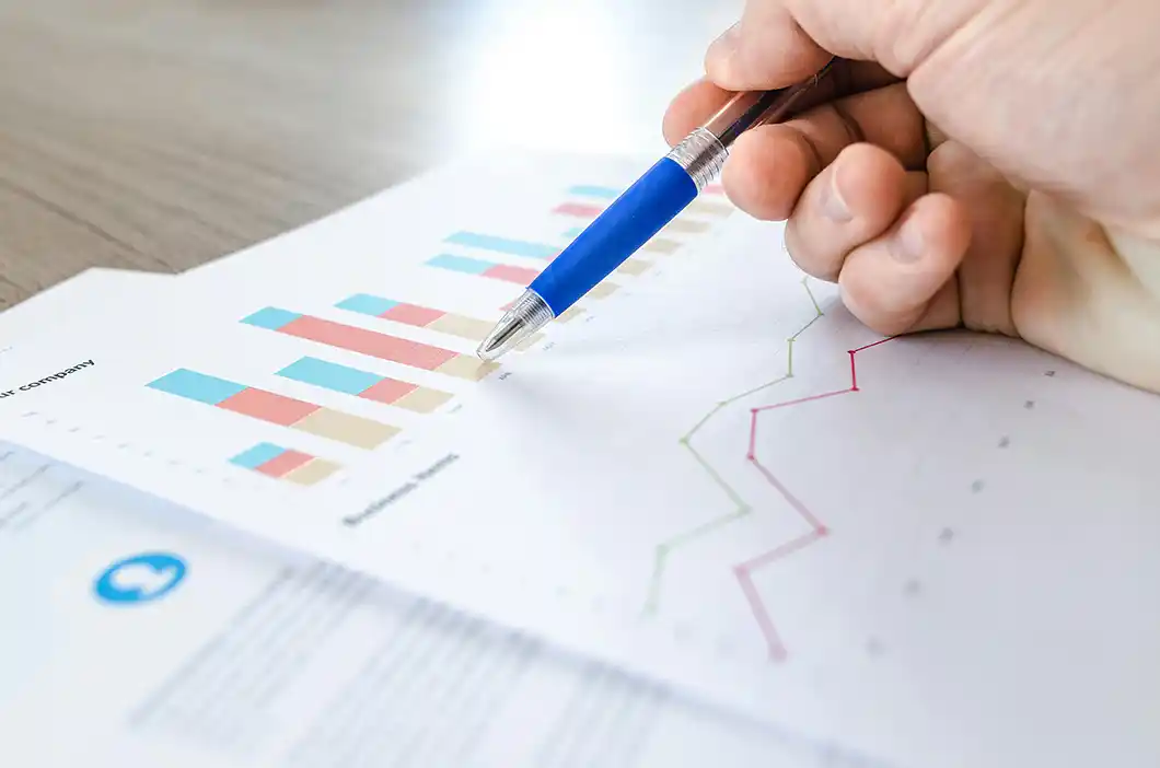 hand-with-pen-pointing-to-chart