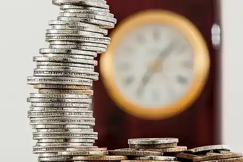 stack-of-coins-before-clock
